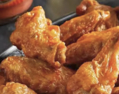 Sauced buffalo chicken wings on a tray