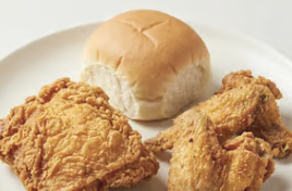 Crispy fried chicken pieces served with a fresh roll