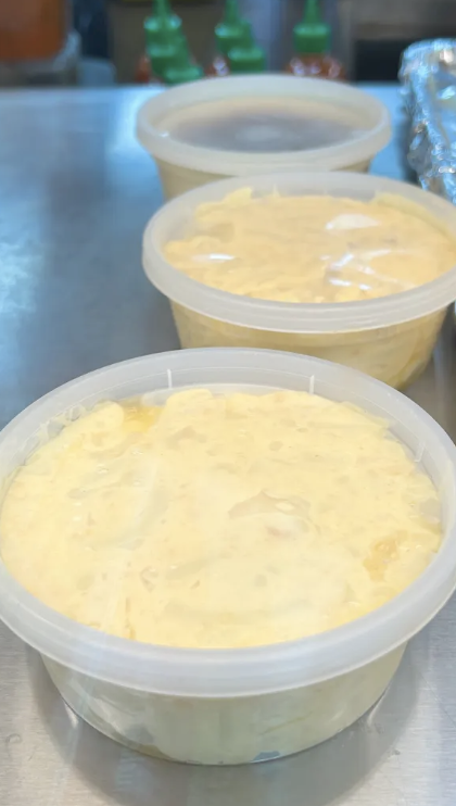 Three containers of creamy macaroni salad