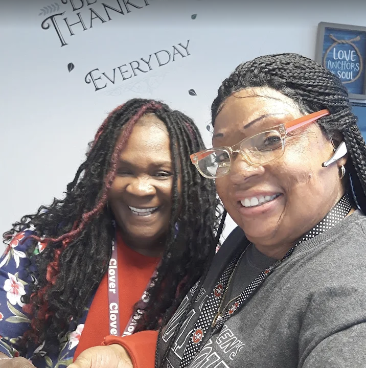 US Fried Chicken team members smiling behind the counter